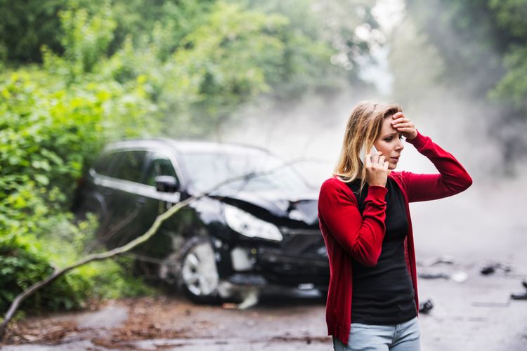woman on the phone with a car accident lawyer after a car accident