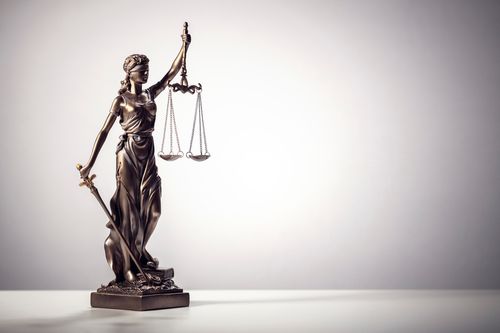 Image is of a a statue of lady justice and scales, concept of Winston Salem bicycle accident lawyer