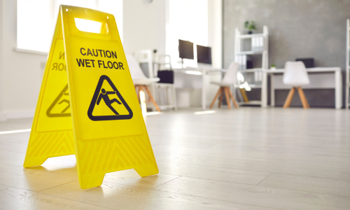 Image is of a caution wet floor sign, concept of Winston Salem slip and fall lawyer