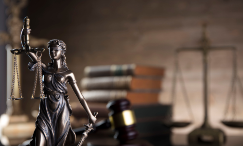 Image is of a statue of lady justice and a judge's gavel, concept of Winston Salem suspended license lawyer