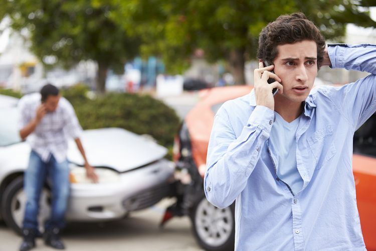 man on the phone to get a lawyer after car accident