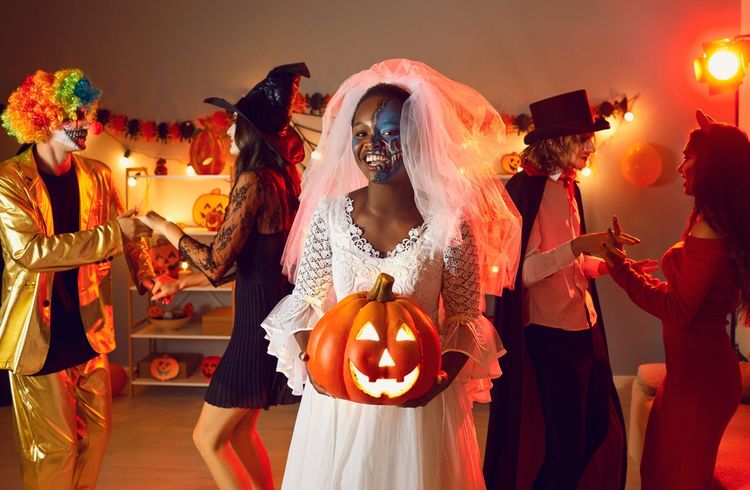 Halloween party, girl holding pumpkin
