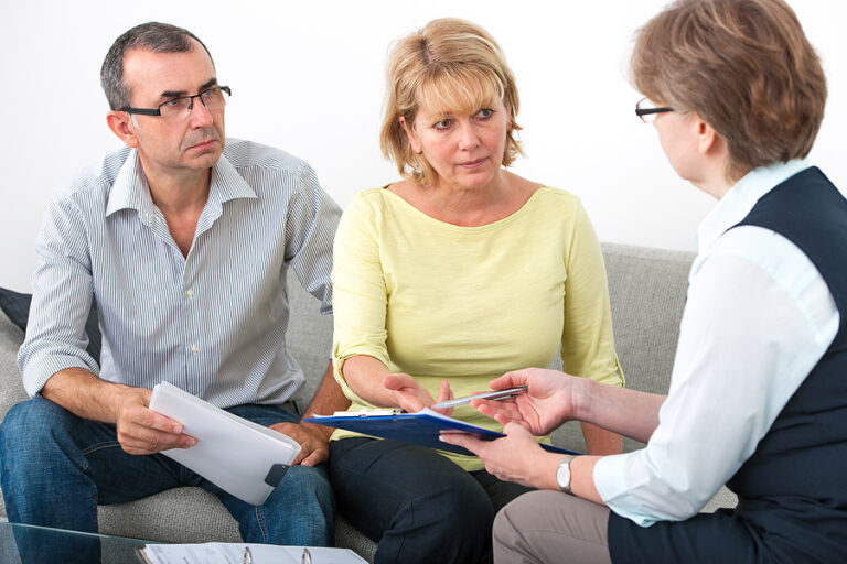 After a Car Accident - couple talking with an insurance agent